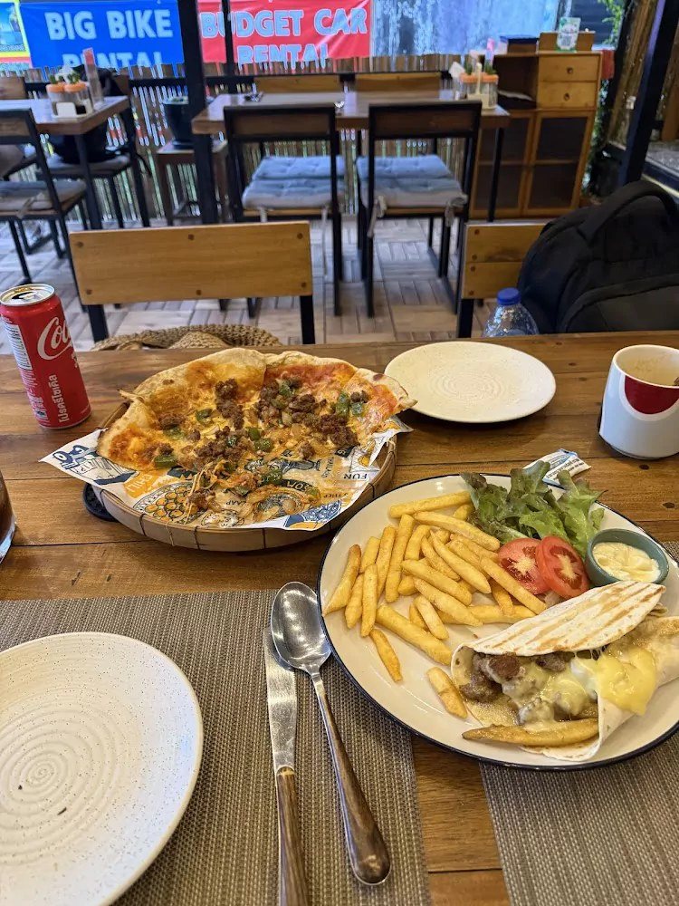 Pizza, fries and a chicken wrap with salad