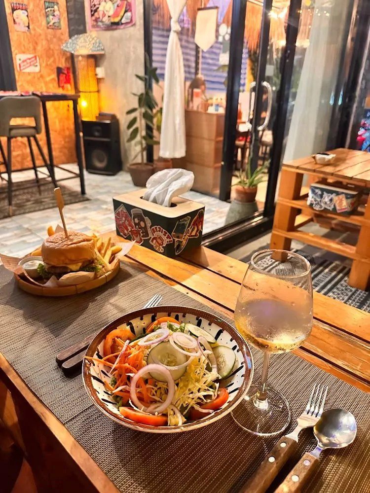 Burger and fresh salad on a wooden table