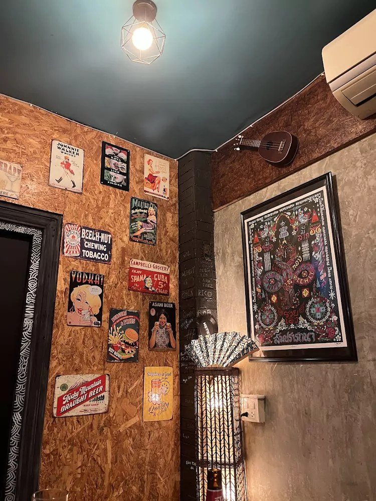 Wall of vintage tin signs and artwork inside Crash